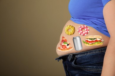 Image of Overweight woman in tight shirt and jeans with images of different unhealthy food on her belly against light brown background, closeup. Space for text