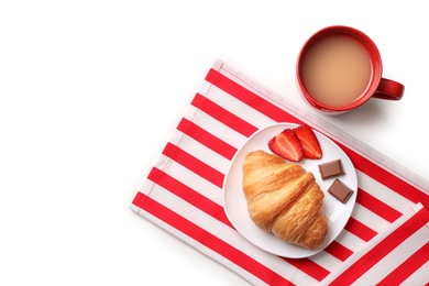 Plate with tasty croissant and cup of coffee on light background, top view