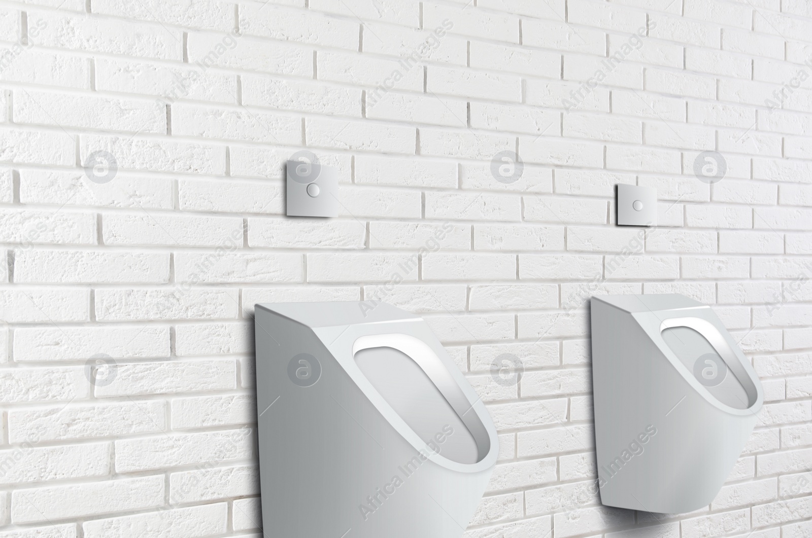 Image of Clean ceramic urinals in men's public bathroom