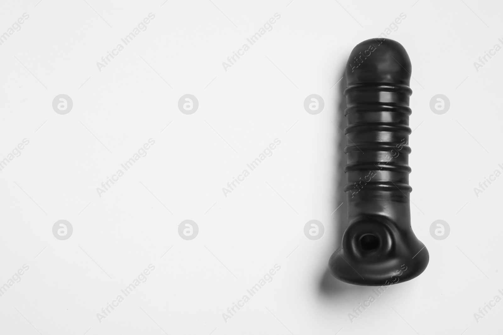 Photo of Black sex toy on white background, top view