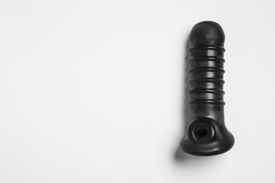 Photo of Black sex toy on white background, top view