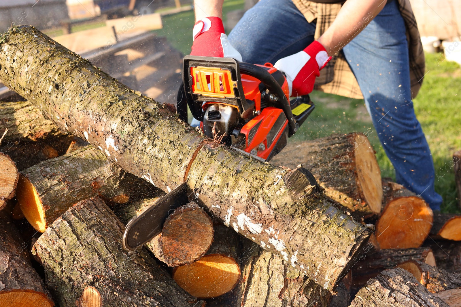 Photo of Man sawing wood on sunny day, closeup view