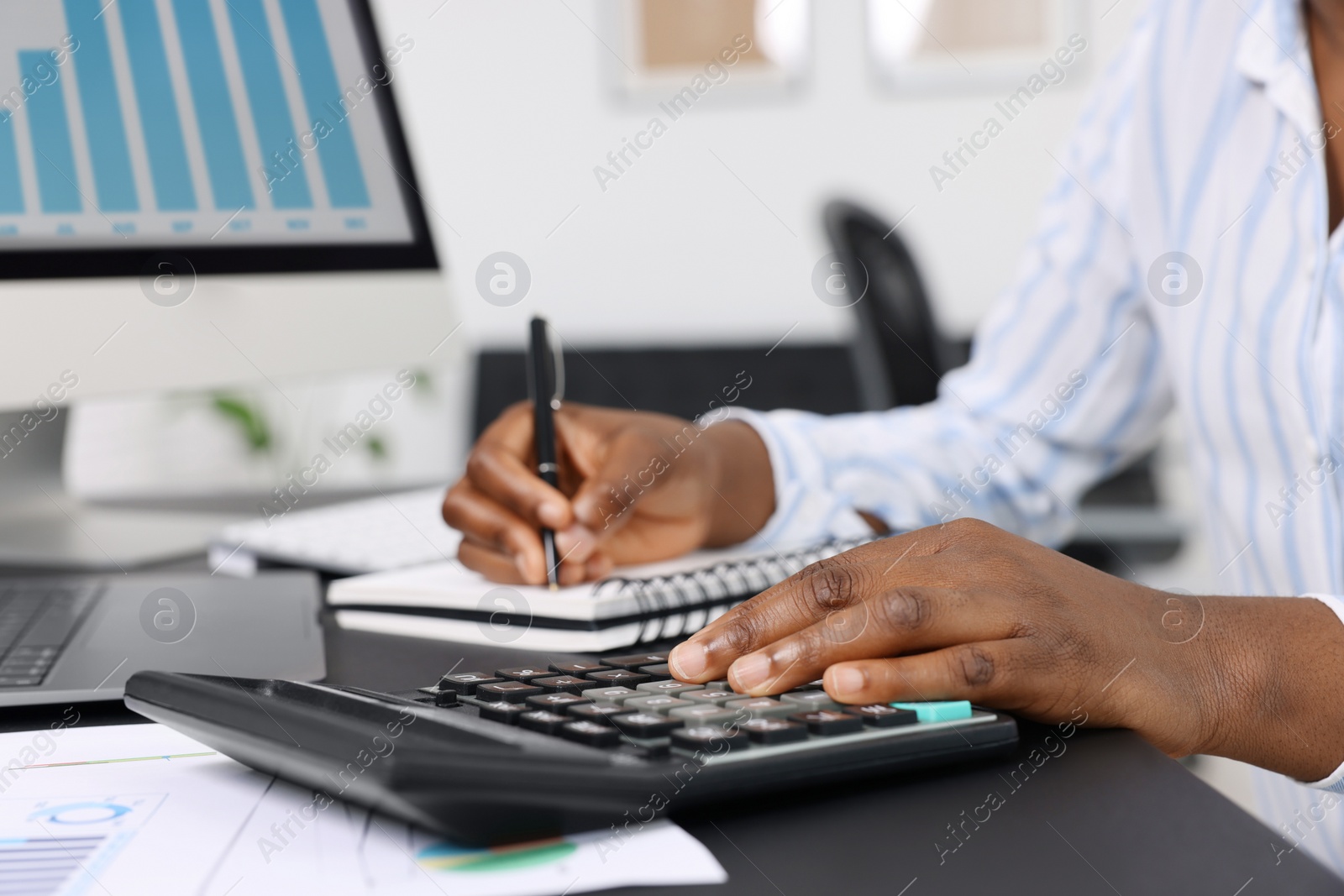 Photo of Professional accountant working at desk in office, closeup