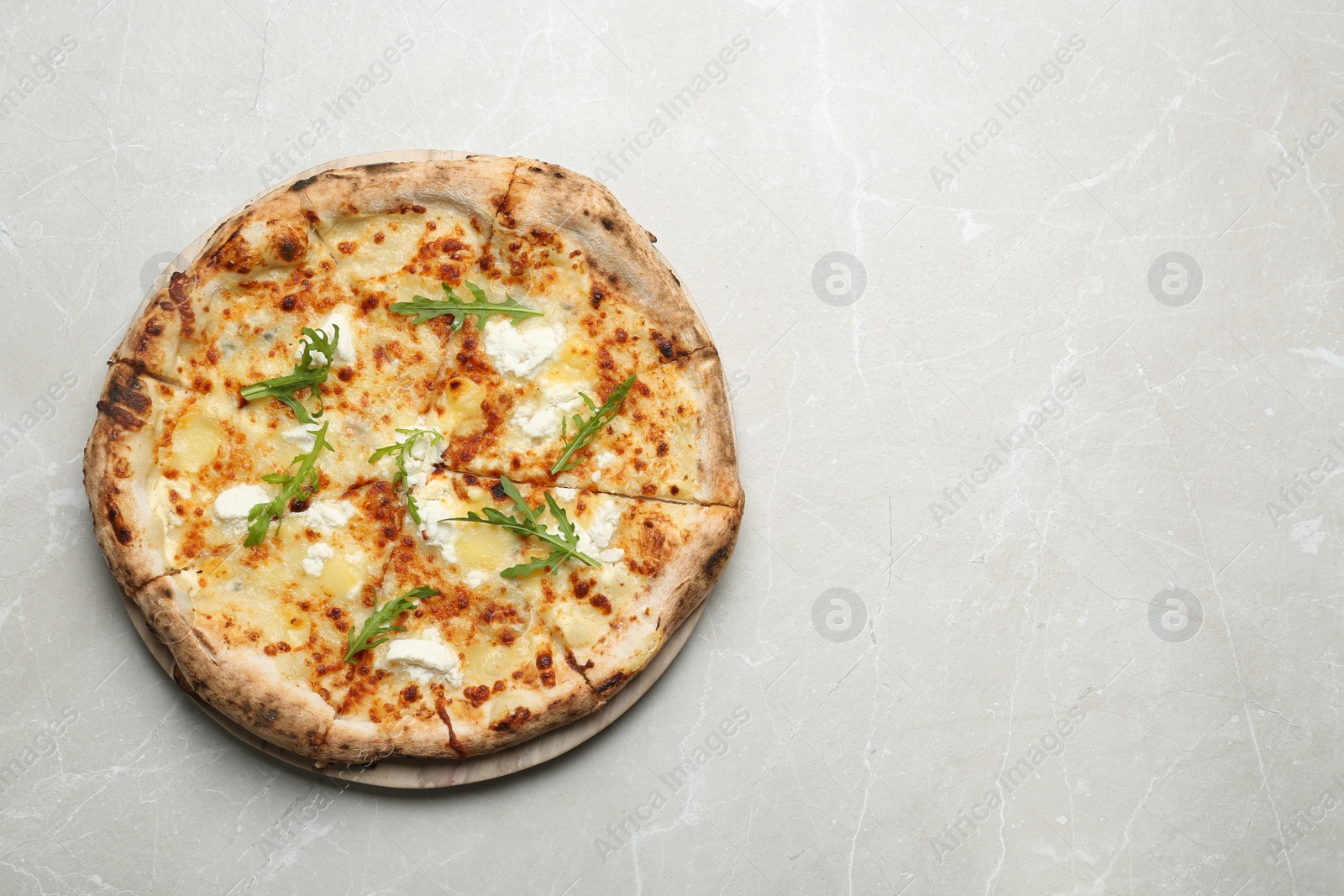 Image of Tasty cheese pizza on light marble table, top view. Space for text