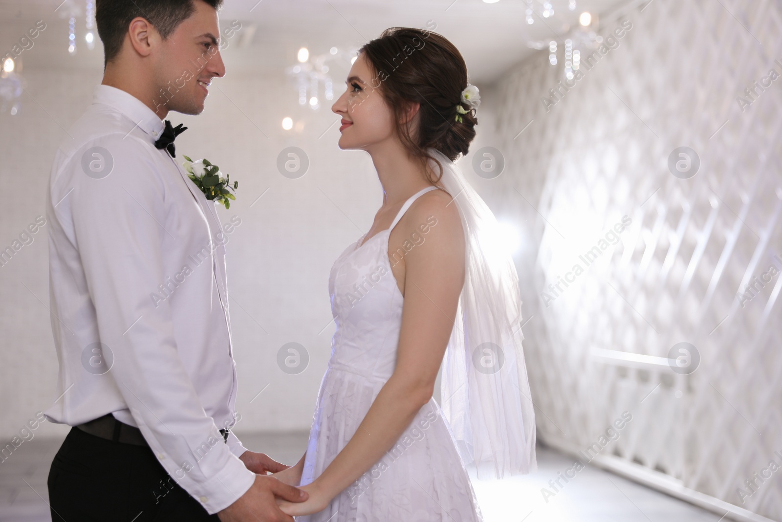 Photo of Happy newlywed couple together in festive hall