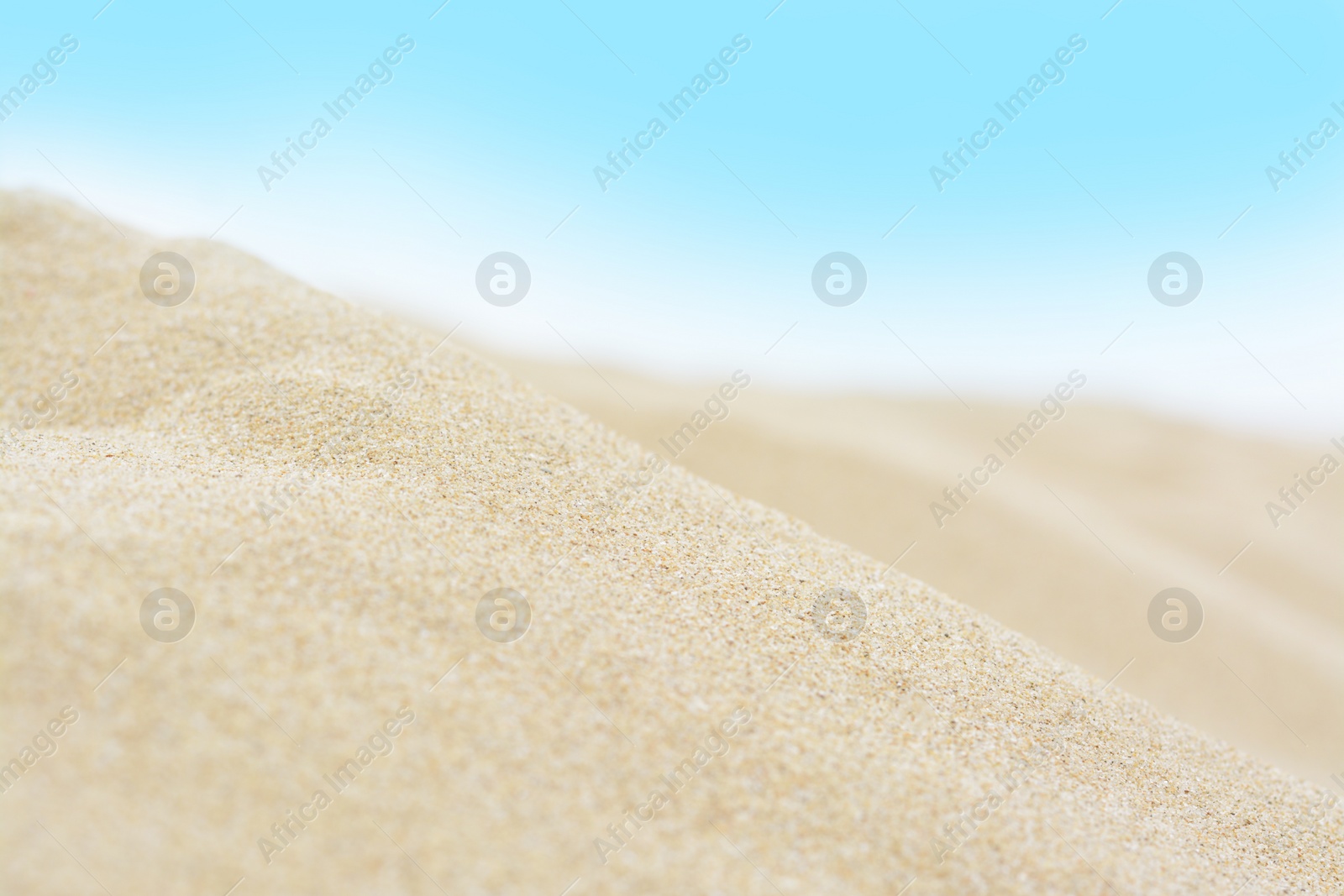 Photo of Beautiful view of sandy beach on summer day, closeup