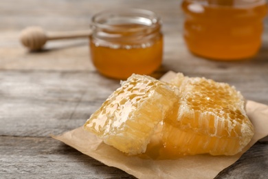 Photo of Fresh honeycomb on wooden table, closeup