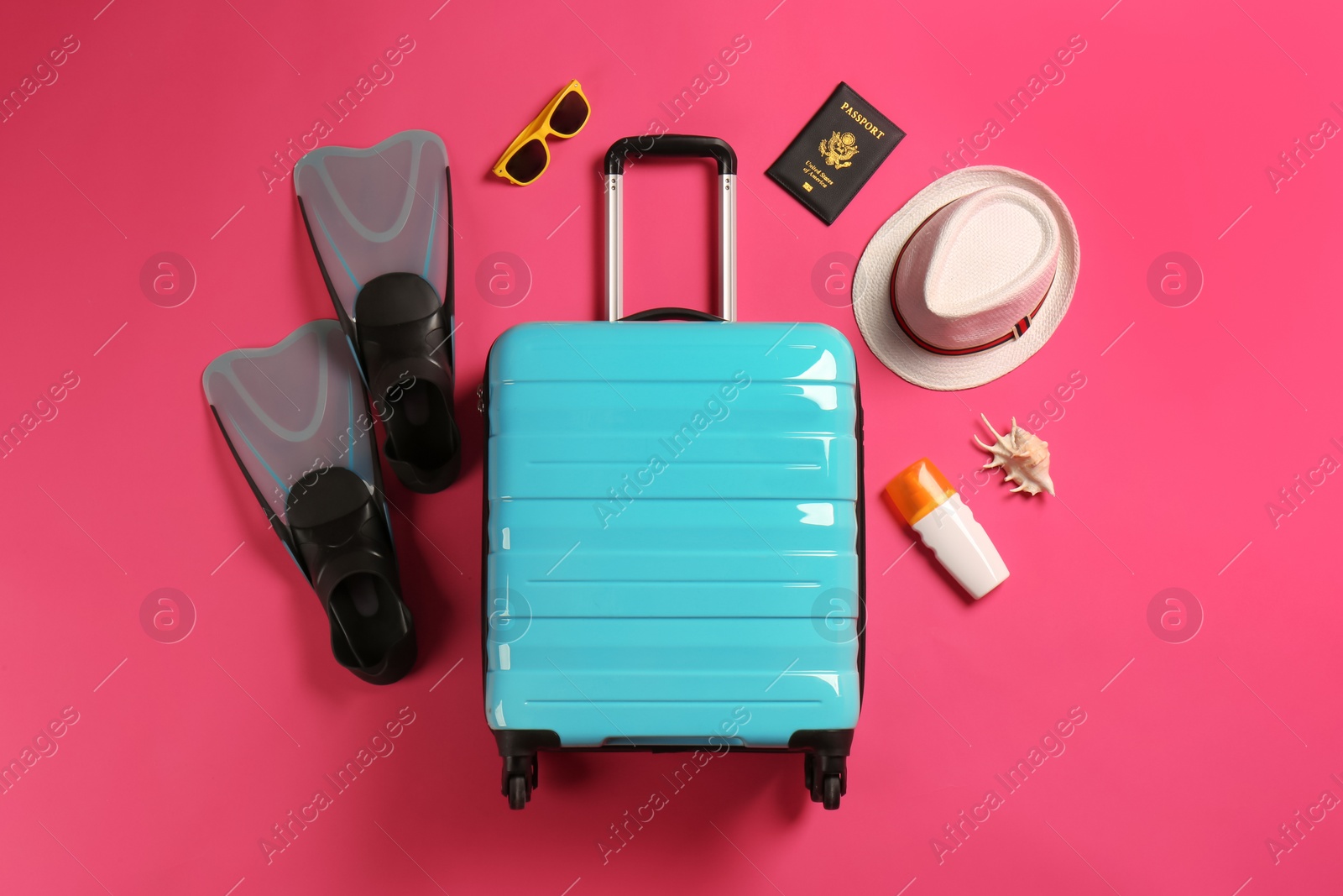 Photo of Flat lay composition with suitcase and traveler's accessories on color background