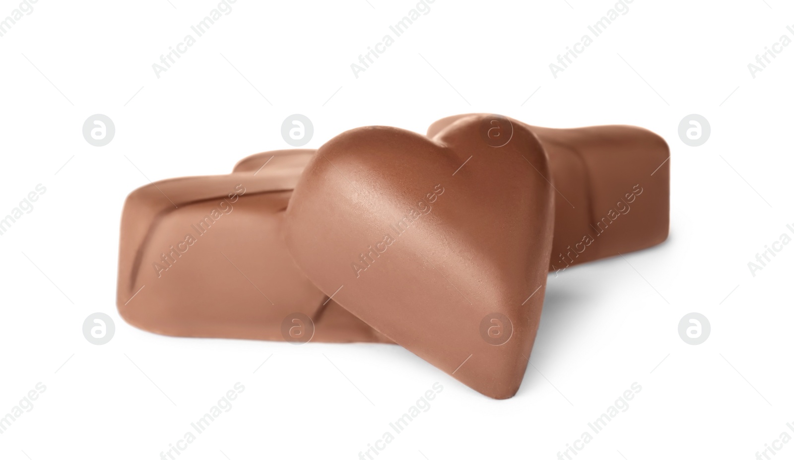 Photo of Tasty heart shaped chocolate candies on white background. Valentine's day celebration