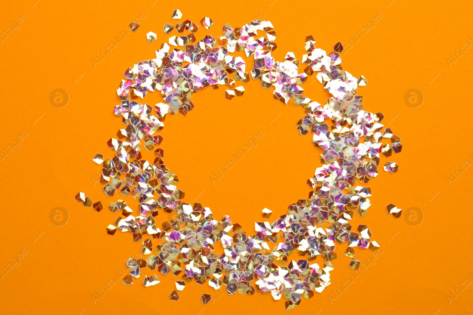 Photo of Frame made with shiny glitter on orange background, flat lay
