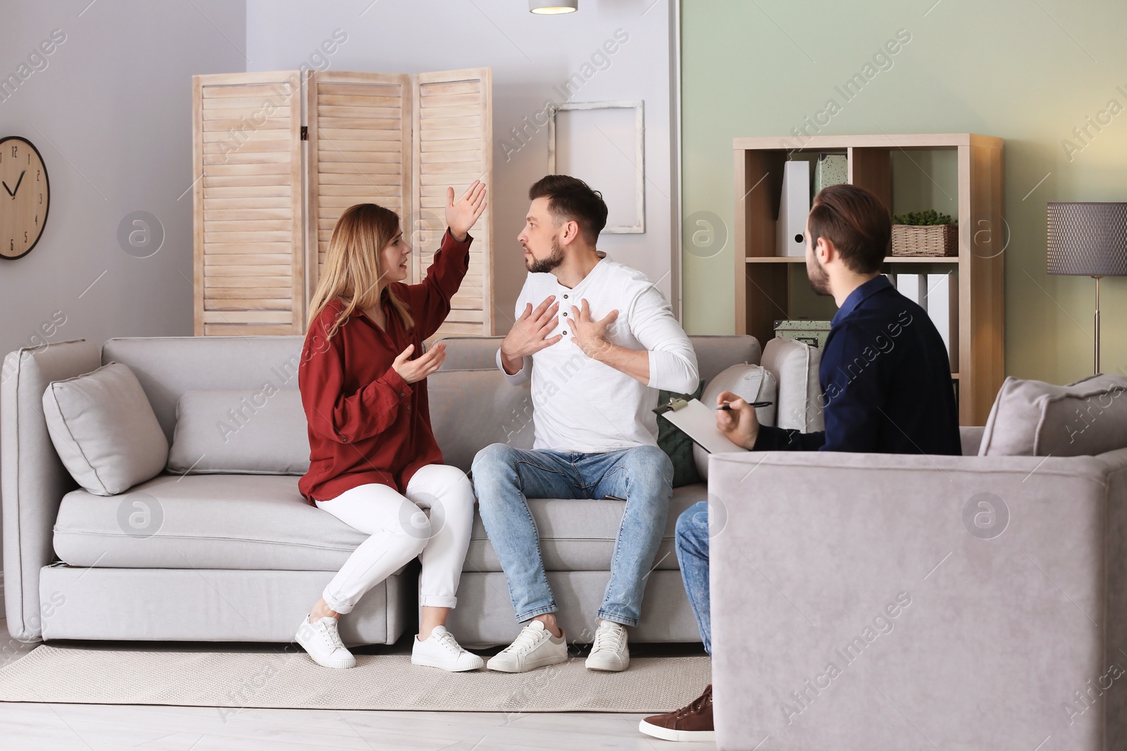 Photo of Family psychologist working with young couple in office