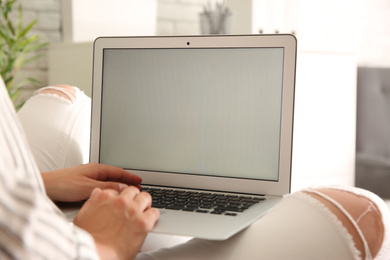 Woman working with modern laptop indoors, closeup. Space for design