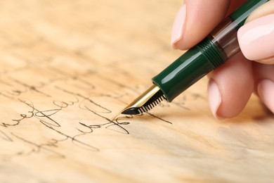 Woman writing letter with fountain pen, closeup