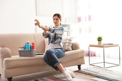 Happy woman having fun while cleaning room