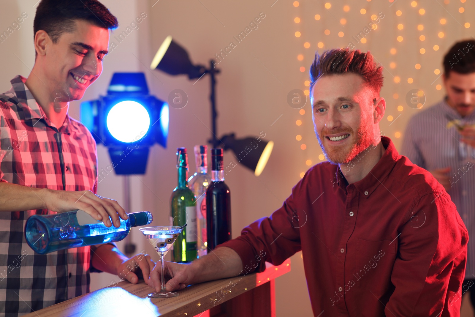 Photo of Young man with glass of martini cocktail at party