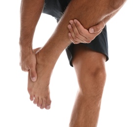 Photo of Man suffering from foot pain on white background, closeup