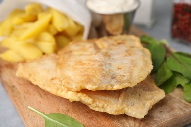 Photo of Delicious fish and chips with mangold on table, closeup