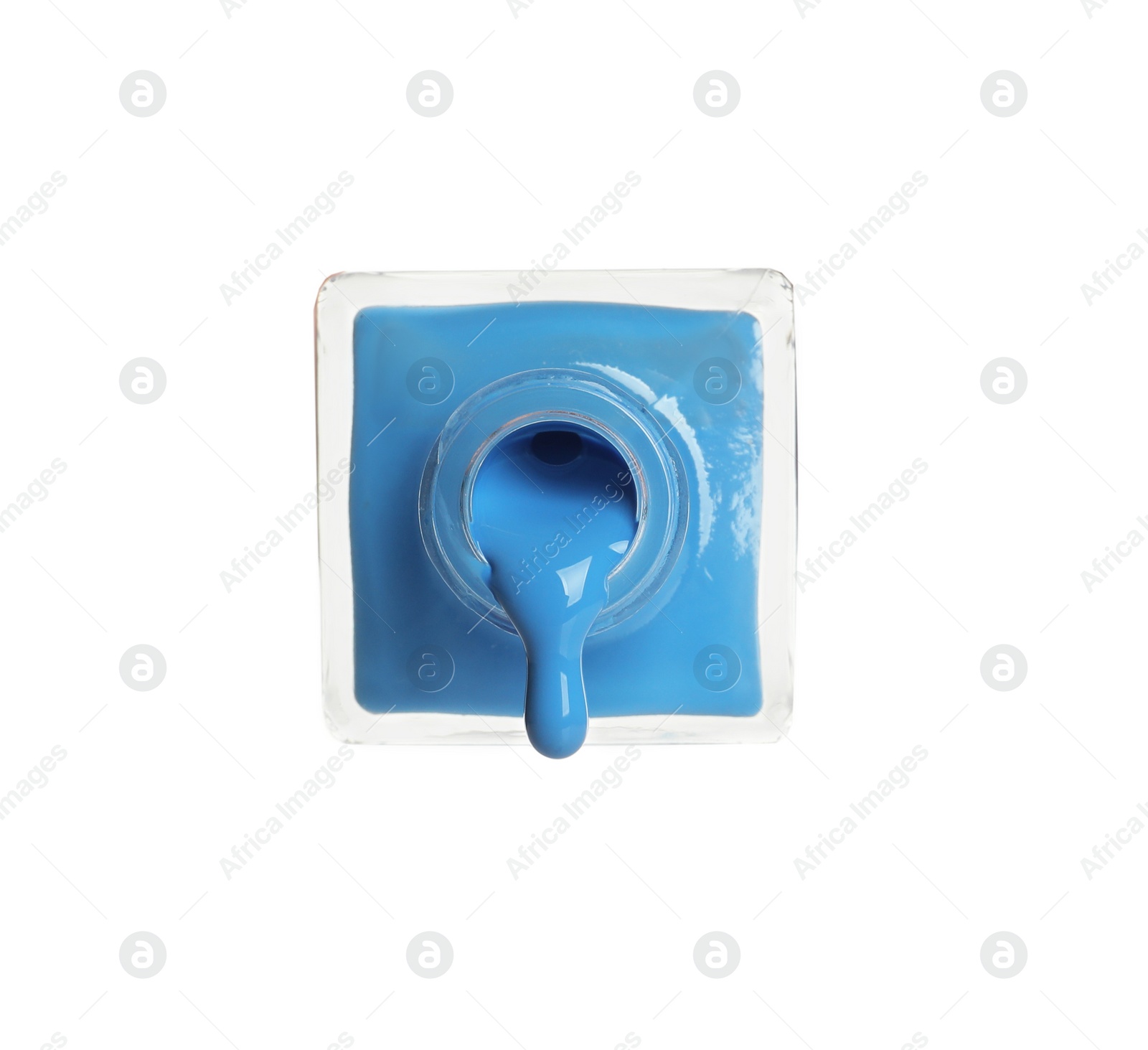 Photo of Pouring color nail polish from bottle on white background