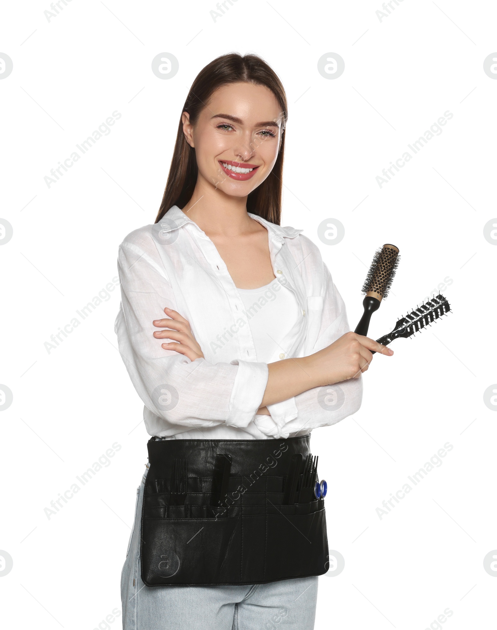 Photo of Portrait of happy hairdresser with brushes on white background