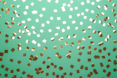 Photo of Confetti on green background, flat lay. Christmas celebration