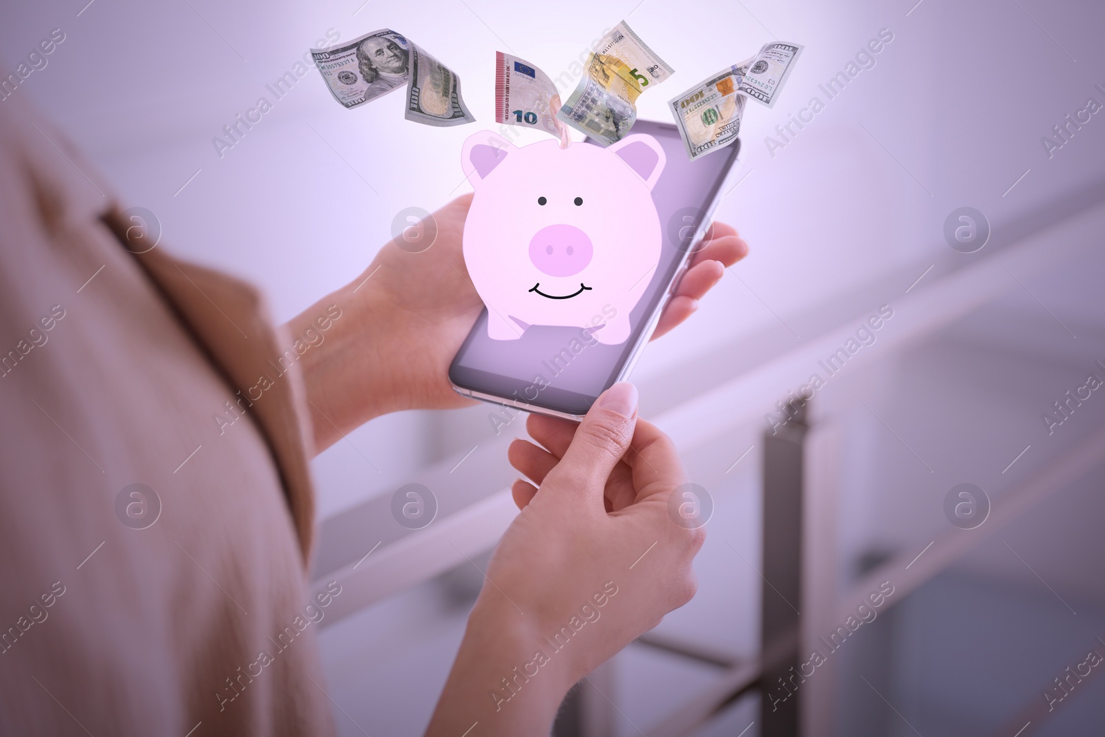 Image of Woman using online bank application on her smartphone indoors