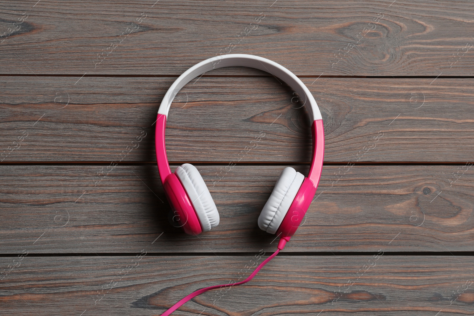 Photo of Stylish headphones on wooden background, top view