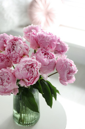 Photo of Bouquet of beautiful peonies on table indoors