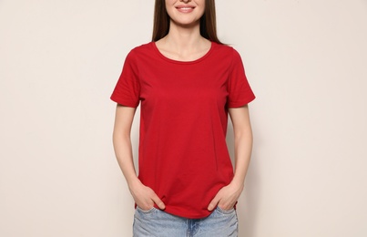 Young woman in t-shirt on light background, closeup. Mock up for design