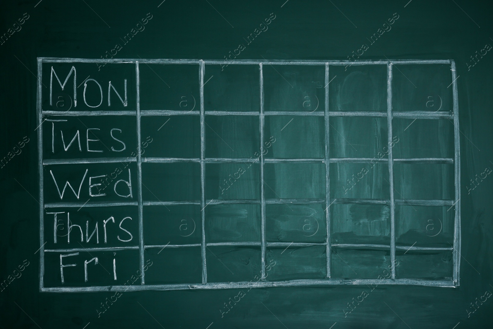 Photo of Weekly school timetable drawn on green chalkboard