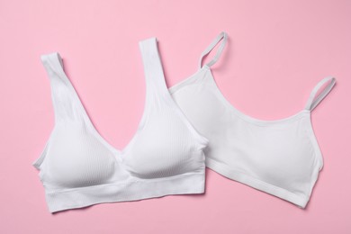 Photo of Stylish white women's underwear on pink background, flat lay