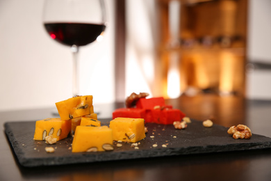 Photo of Delicious gouda cheese and walnuts on table, closeup
