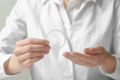 Photo of Doctor holding diaphragm vaginal contraceptive ring, closeup