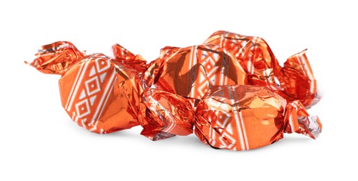 Candies in orange wrappers isolated on white