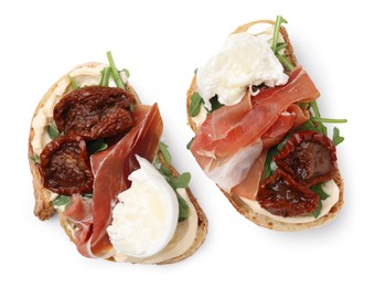 Photo of Delicious sandwiches with burrata cheese, ham and sun-dried tomatoes isolated on white, top view