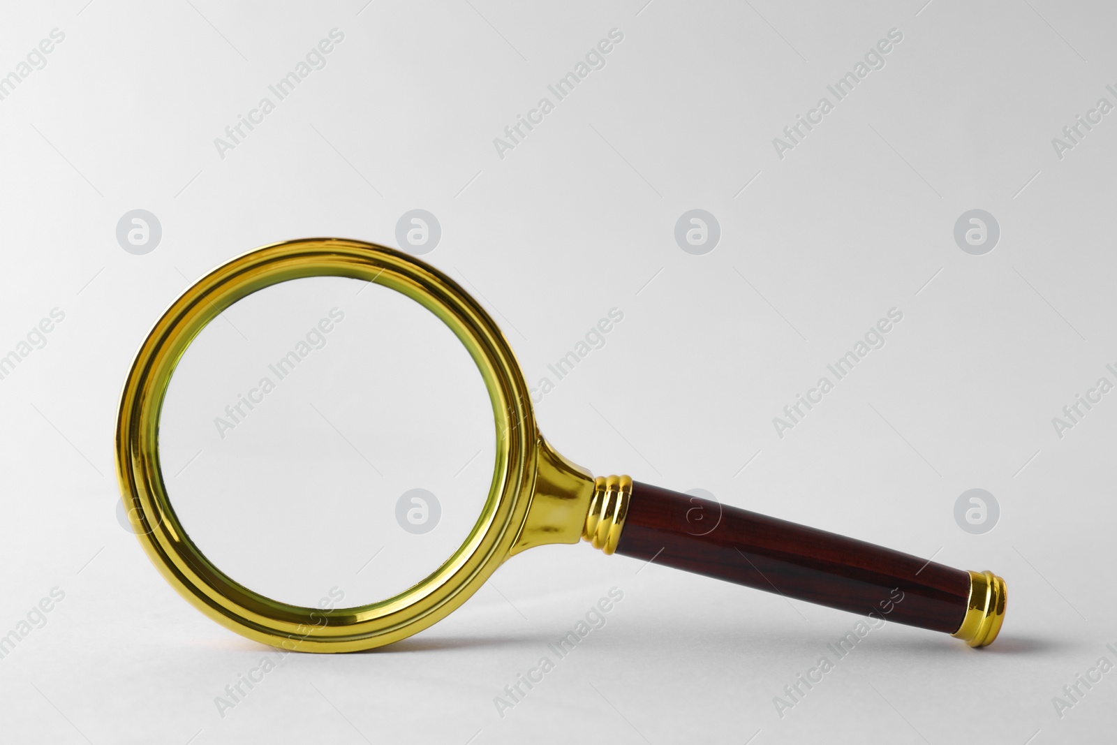 Photo of Magnifying glass with handle on white background