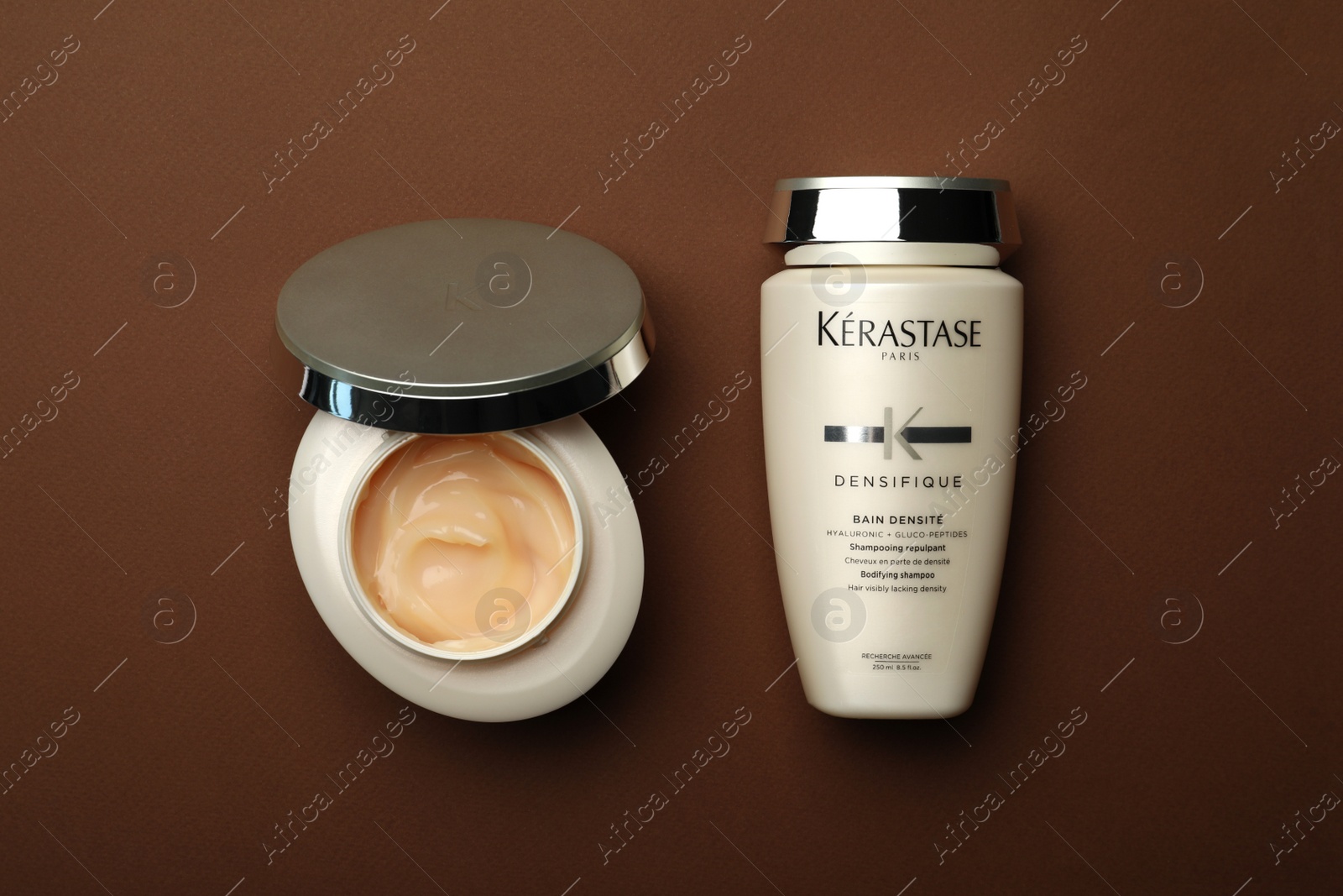 Photo of MYKOLAIV, UKRAINE - SEPTEMBER 07, 2021: Kerastase hair care cosmetic products on brown background, flat lay