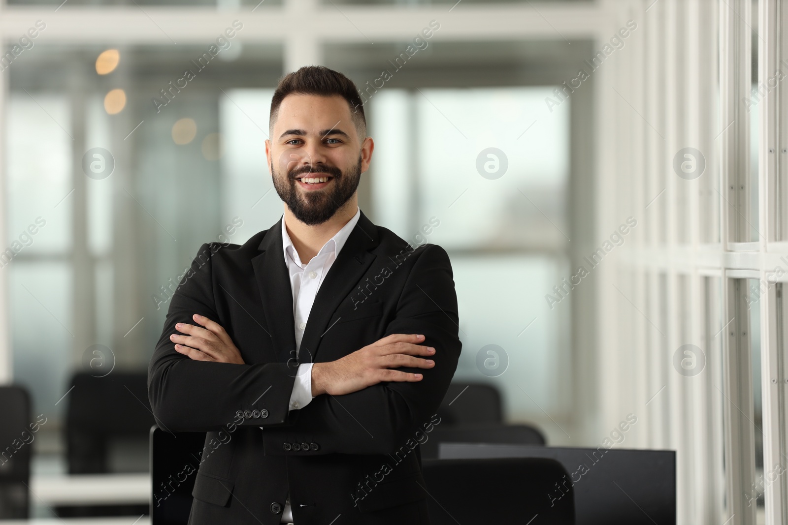 Photo of Portrait of smiling man with crossed arms in office, space for text. Lawyer, businessman, accountant or manager