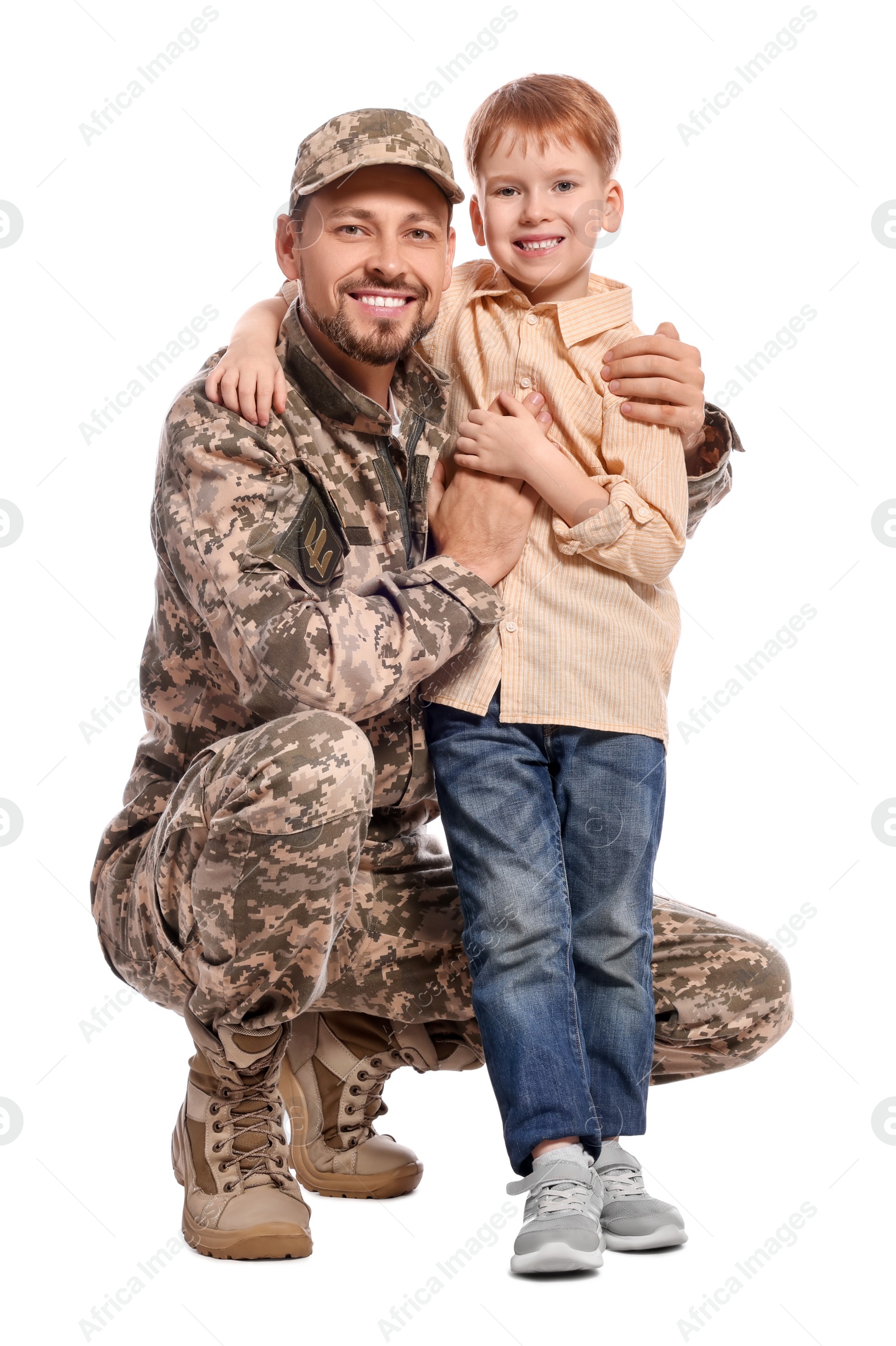 Photo of Ukrainian defender in military uniform with his little son on white background