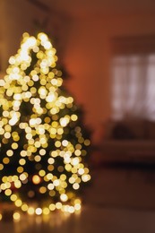 Photo of Blurred view of living room interior with decorated Christmas tree