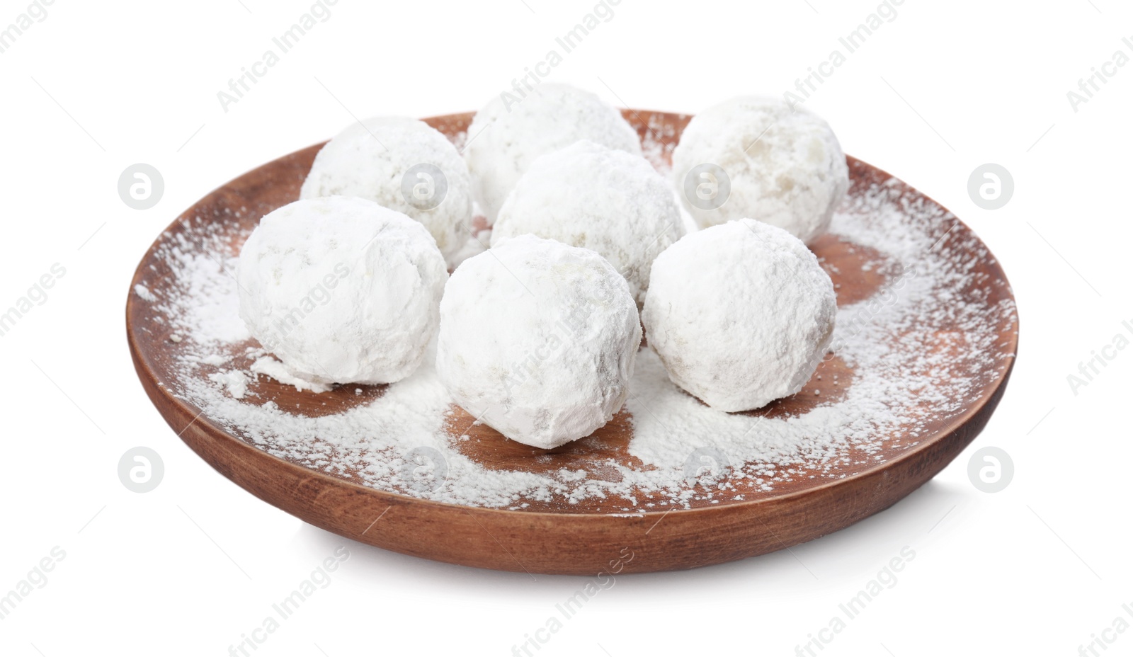 Photo of Wooden plate with Christmas snowball cookies isolated on white