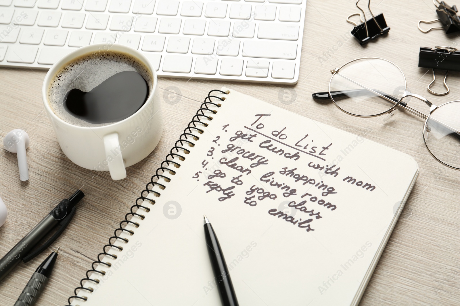 Photo of Notebook with to do list on wooden table