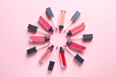 Photo of Composition of lipsticks on color background, flat lay