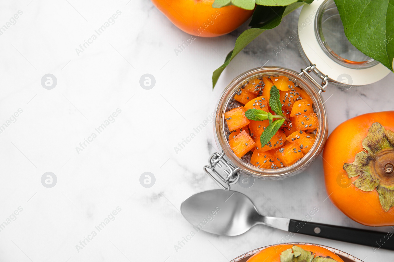 Photo of Delicious dessert with persimmon and chia seeds on table, flat lay. Space for text