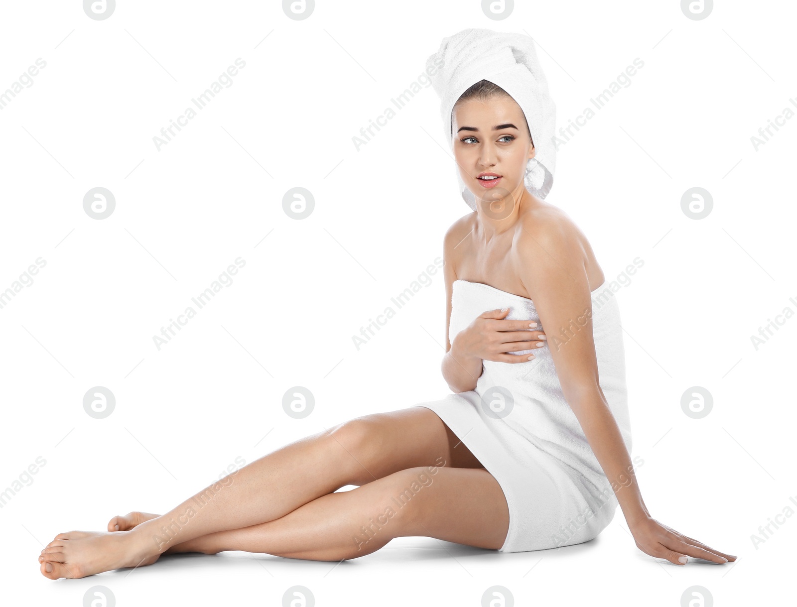 Photo of Portrait of young pretty woman with towels sitting on white background