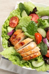 Photo of Delicious salad with chicken and vegetables on table, top view