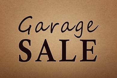 Words Garage Sale on brown paper, top view