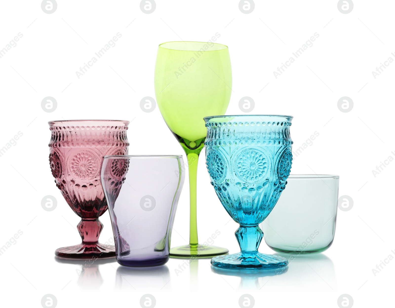 Photo of Set of colorful empty glasses on white background