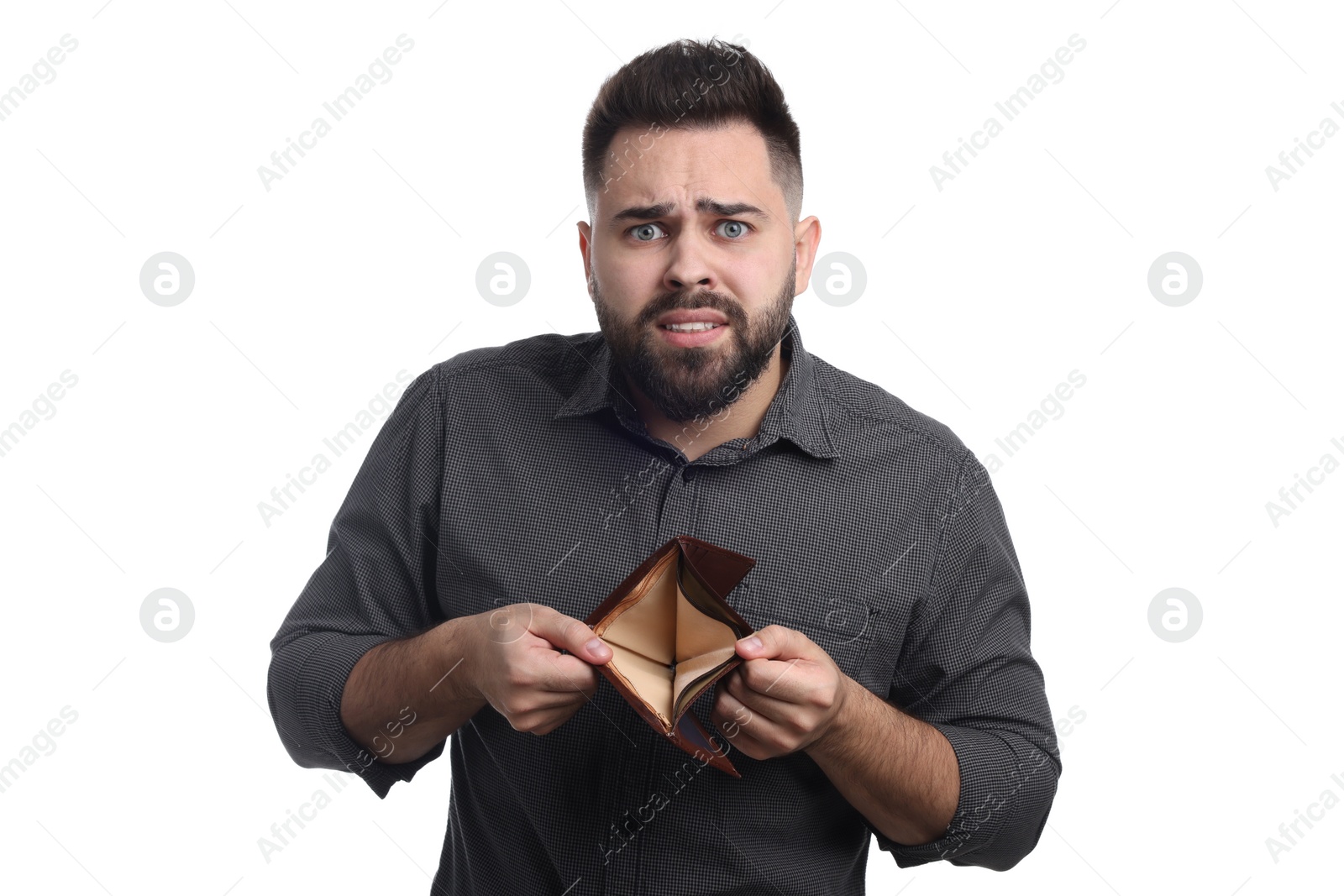 Photo of Confused man showing empty wallet on white background