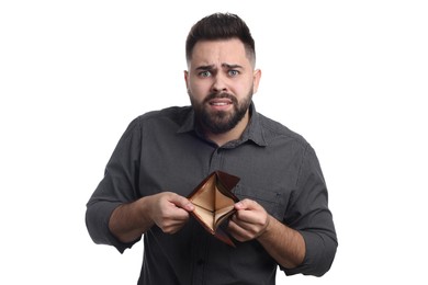 Confused man showing empty wallet on white background