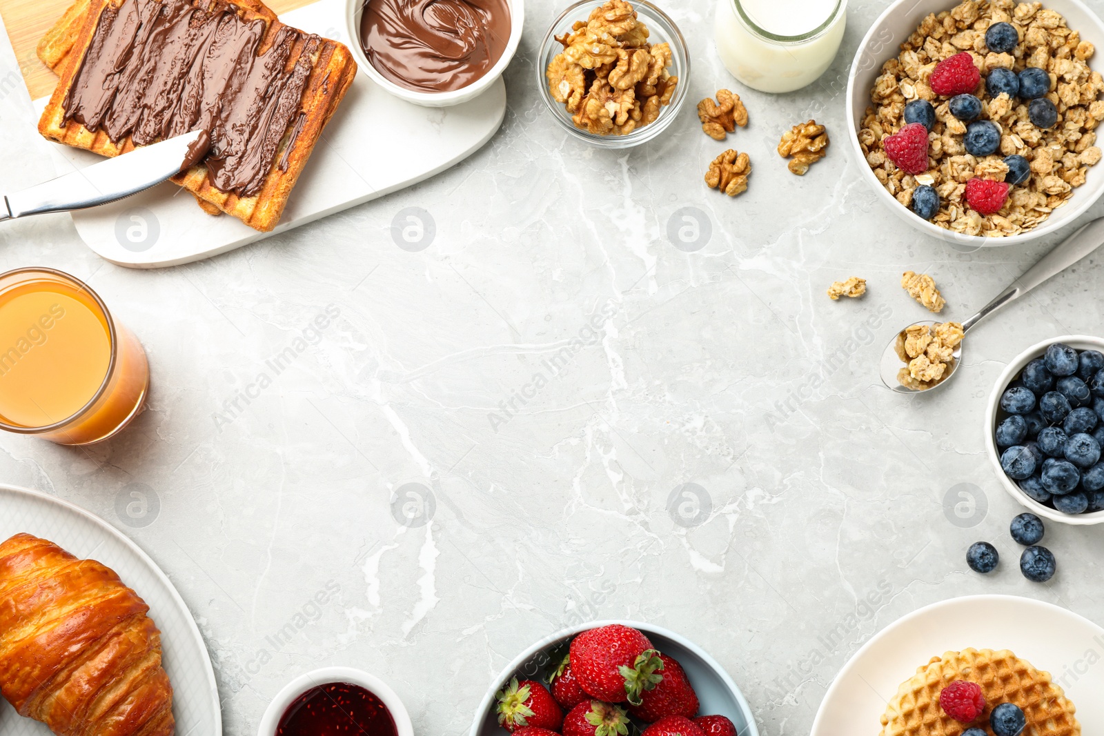 Photo of Frame made with tasty breakfast on light grey marble table, flat lay. Space for text